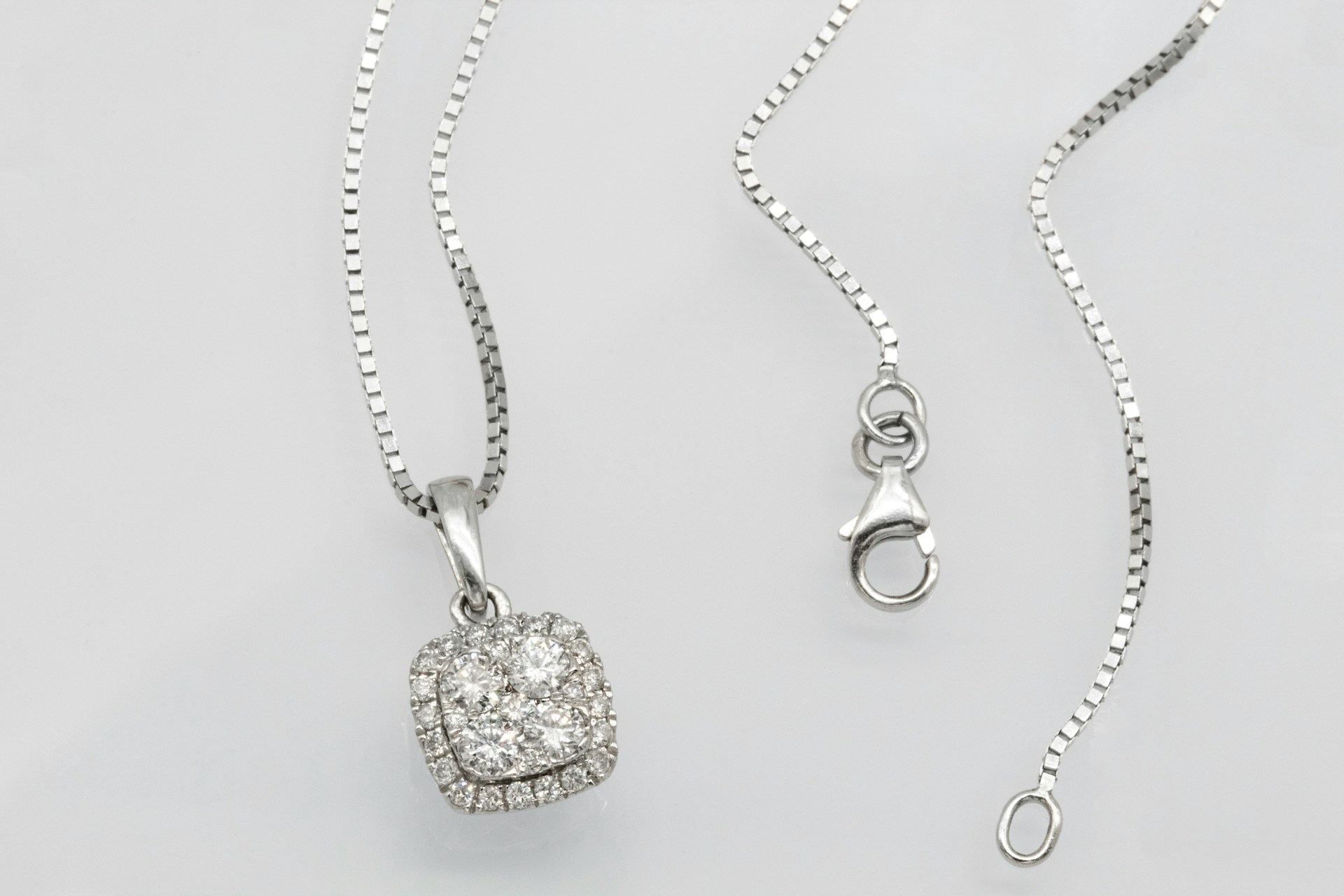 a sterling silver diamond pendant necklace featuring a number of round cut diamonds