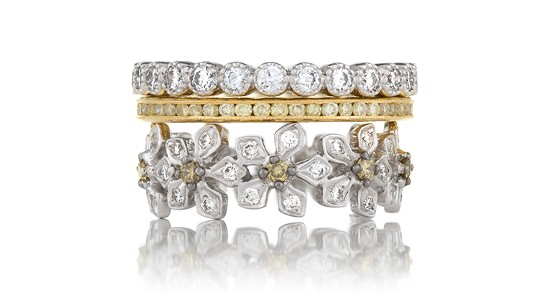 a layered ring featuring mixed metals, diamonds, and floral details