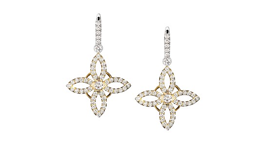 a mixed metal pair of drop earrings with a stylized floral design and diamonds