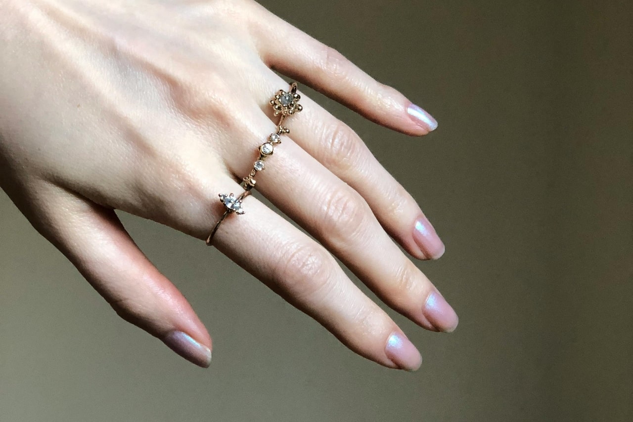 Trio of diamond rings on a woman’s hand.