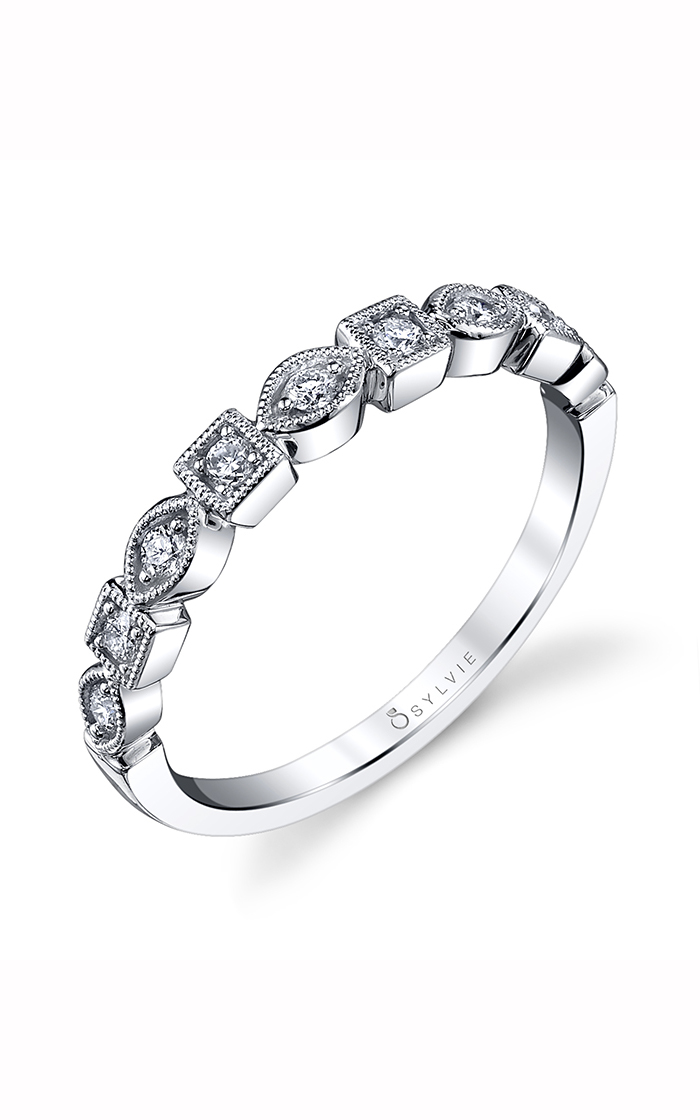 A white gold wedding band with alternating square and marquise-shaped channels, set with round diamonds.