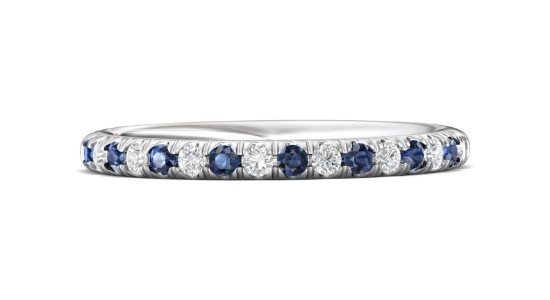 a white gold wedding band featuring prong set sapphires and diamonds