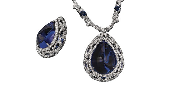 a white gold pendant necklace featuring a pear shaped tanzanite