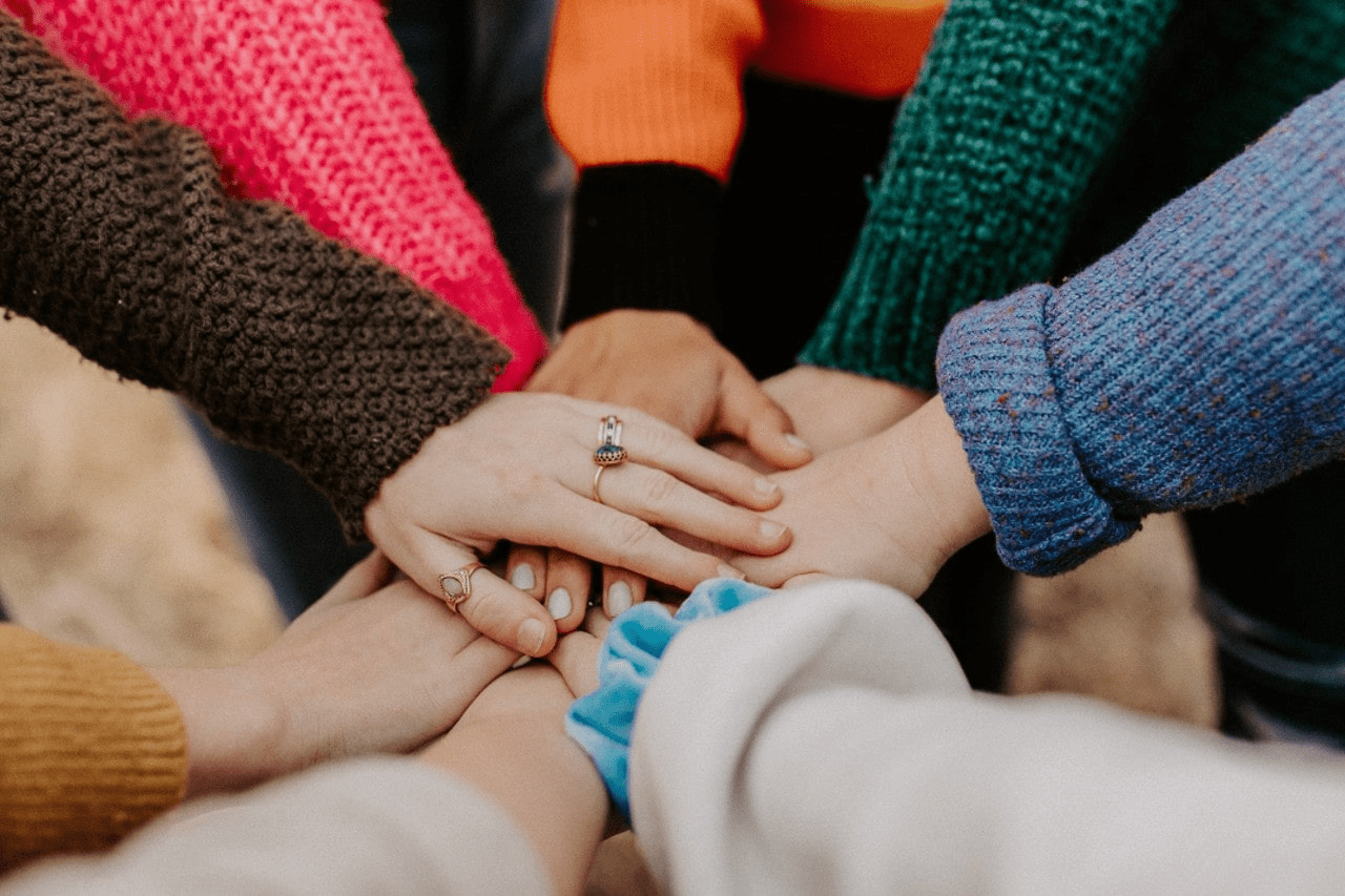 a group of hands coming together and wearing jewelry on Thanksgiving