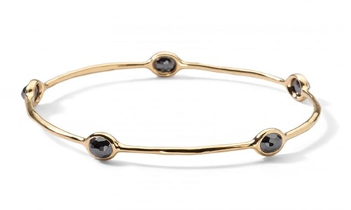 A bezel-set hematite bangle bracelet.