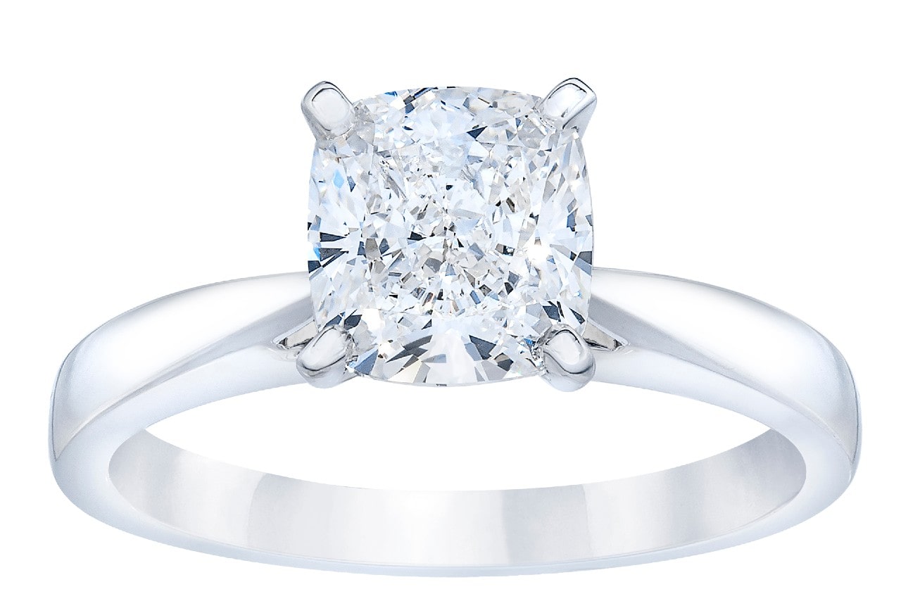 close up image of a silver solitaire engagement ring featuring a radiant cut center stone