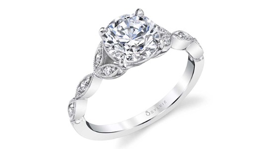 a white gold engagement ring with a nature inspired band