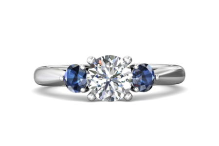 A Martin Flyer three stone engagement ring with 2 sapphires, available at Frank Adams Jewelers.