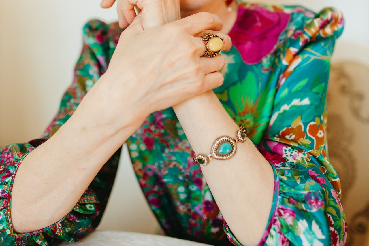 a lady wearing a fashion bracelet and colorful clothing a lady wearing a fashion bracelet and colorful clothing