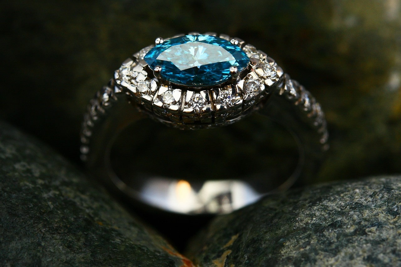 a white gold engagement ring with a blue marquise cut center stone a white gold engagement ring with a blue marquise cut center stone