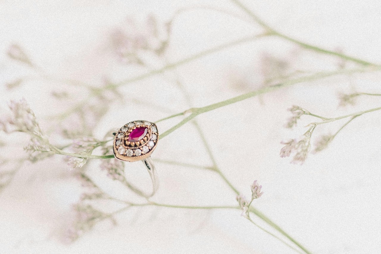 a mixed metal ring with a pink, marquise cut center stone a mixed metal ring with a pink, marquise cut center stone