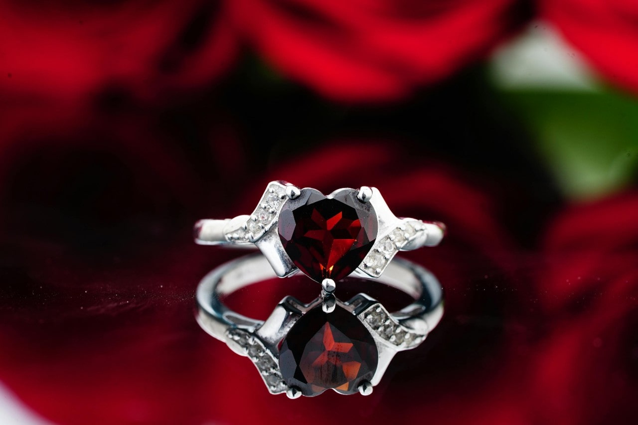 a white gold engagement ring with a heart shape ruby center stone a white gold engagement ring with a heart shape ruby center stone